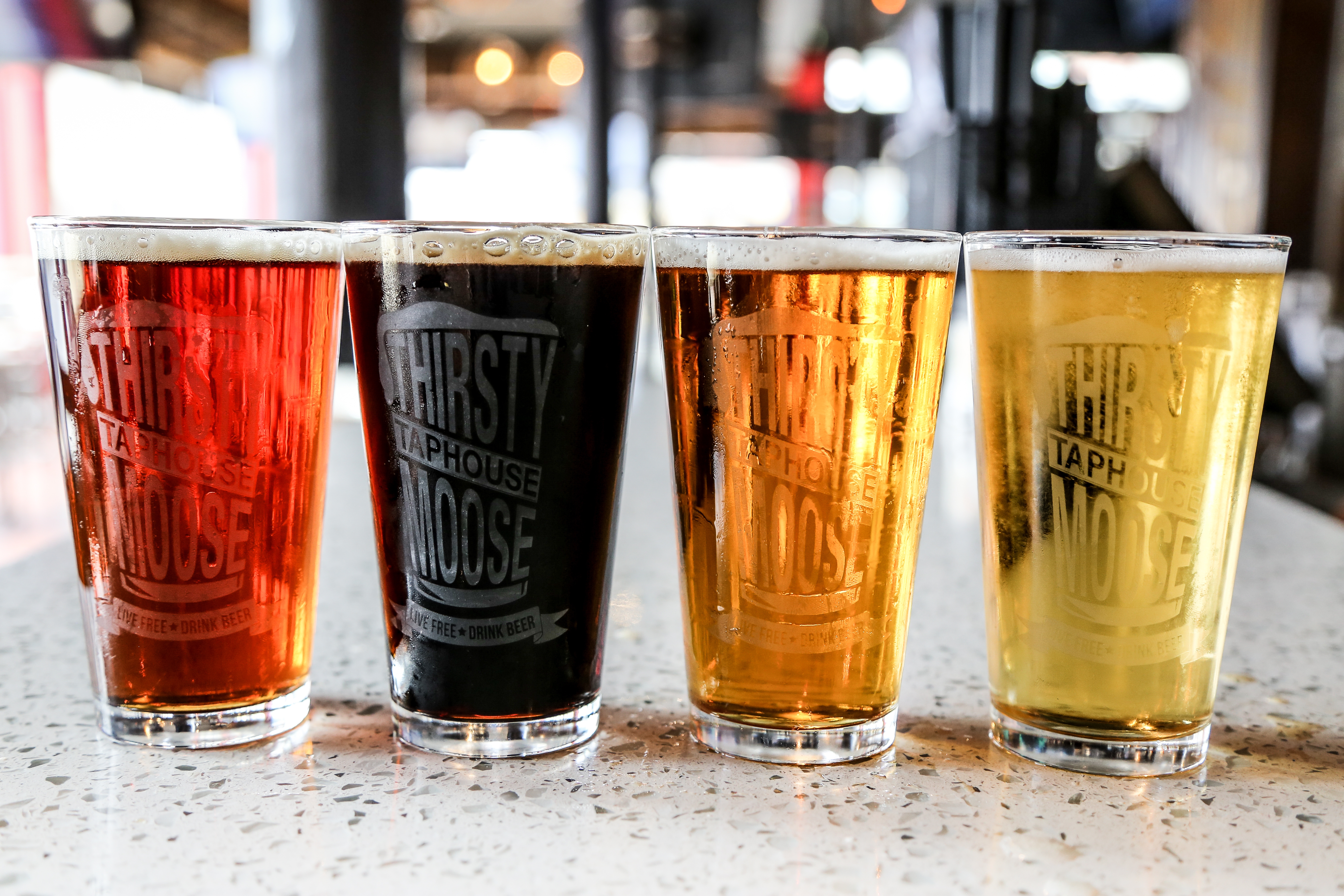 line of dark to light beers on the bar