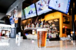 Foamy beer on bar top